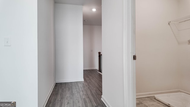 corridor with light hardwood / wood-style floors