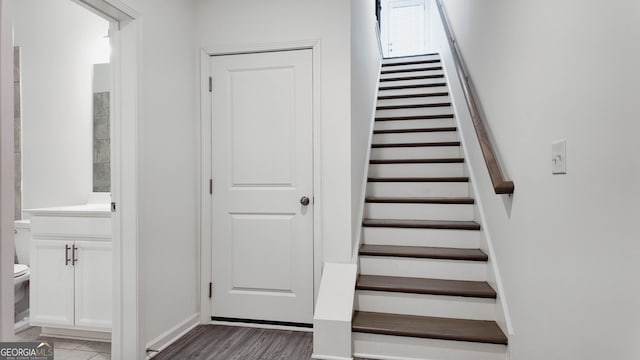 staircase with hardwood / wood-style flooring