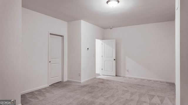 spare room with light colored carpet