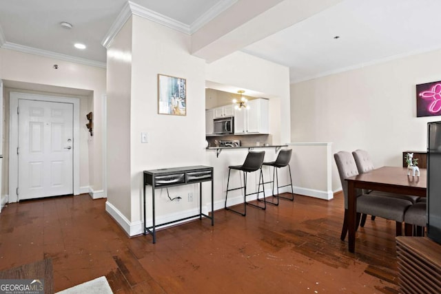 dining space with ornamental molding and dark wood-type flooring