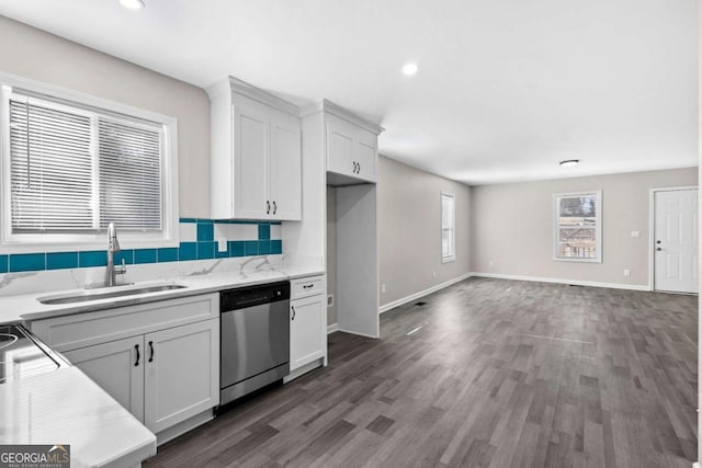 kitchen with tasteful backsplash, dishwasher, dark hardwood / wood-style flooring, white cabinets, and sink