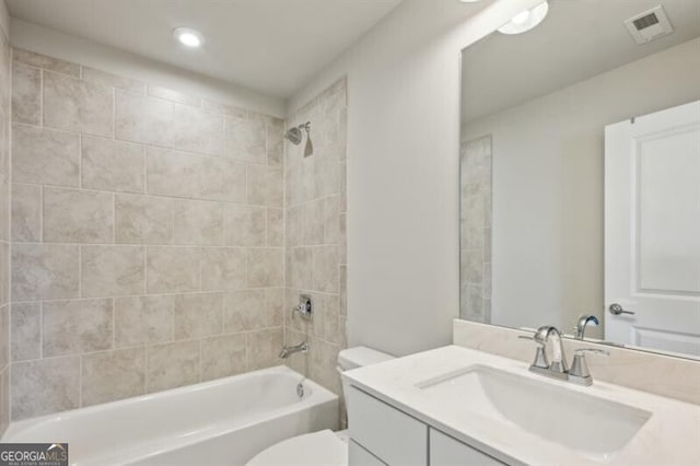 full bathroom featuring vanity, toilet, and tiled shower / bath