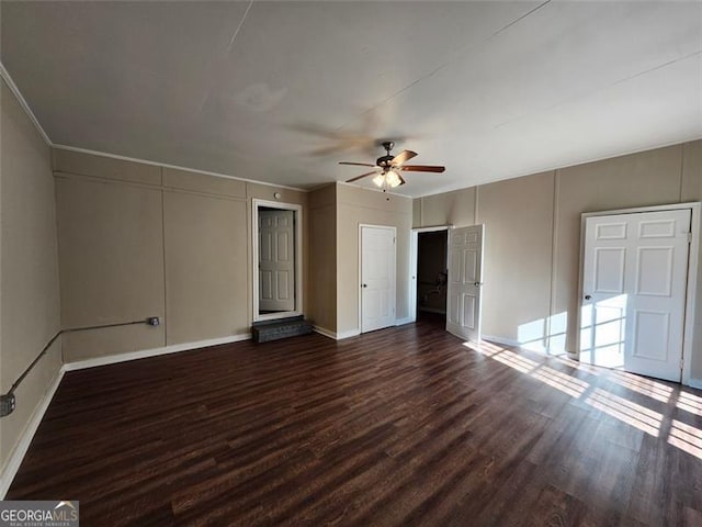 interior space with ceiling fan and dark hardwood / wood-style floors