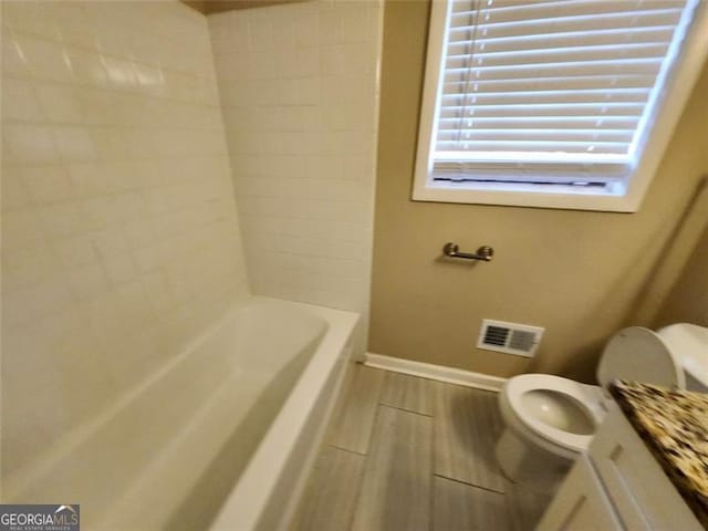 full bathroom with  shower combination, vanity, and toilet