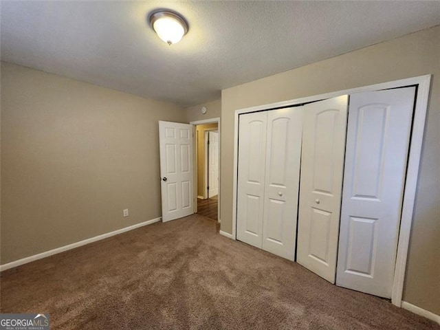 unfurnished bedroom featuring carpet floors and a closet