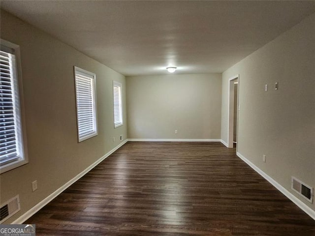 unfurnished room featuring dark hardwood / wood-style flooring