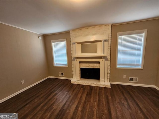 unfurnished living room with ornamental molding, dark hardwood / wood-style flooring, and a fireplace