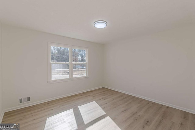 spare room featuring light hardwood / wood-style flooring