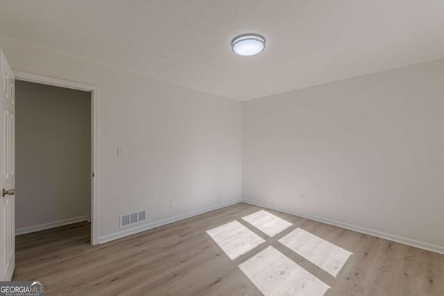 unfurnished room with light hardwood / wood-style flooring