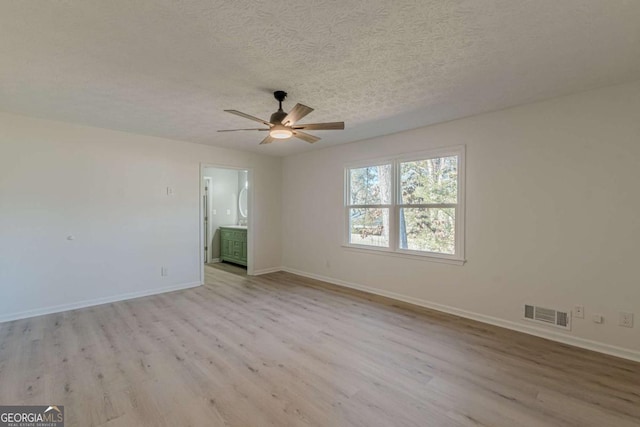 unfurnished room with light wood-type flooring, ceiling fan, and a textured ceiling