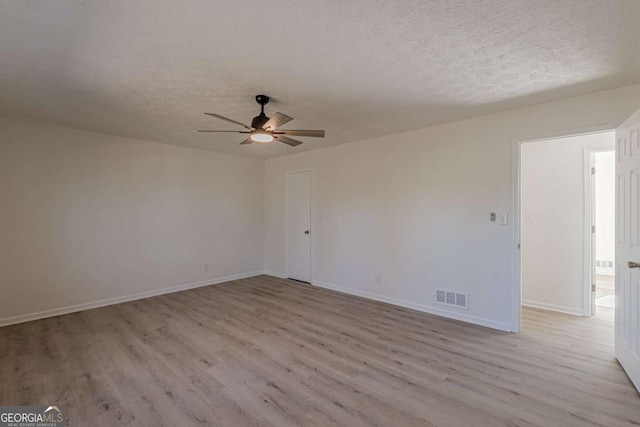 unfurnished room featuring a textured ceiling, ceiling fan, and light hardwood / wood-style flooring