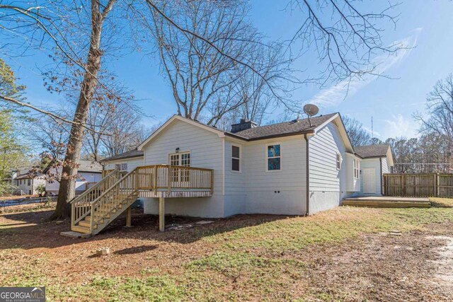 back of property featuring a deck