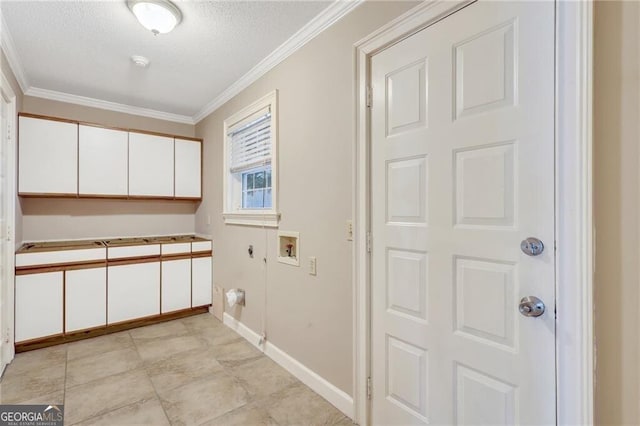 laundry area with a textured ceiling, hookup for an electric dryer, cabinets, ornamental molding, and washer hookup