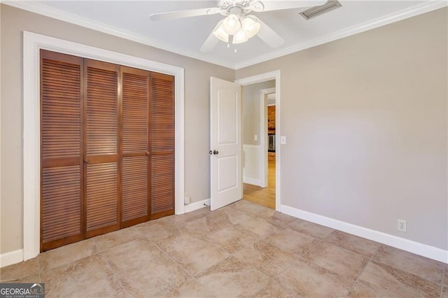 unfurnished bedroom featuring ceiling fan, a closet, and crown molding