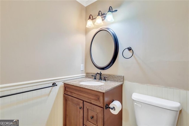 bathroom featuring vanity and toilet