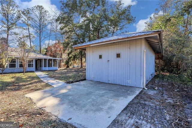 view of outbuilding featuring a sunroom