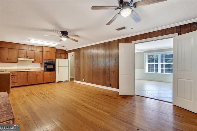 kitchen with crown molding, ceiling fan, black appliances, and light hardwood / wood-style flooring