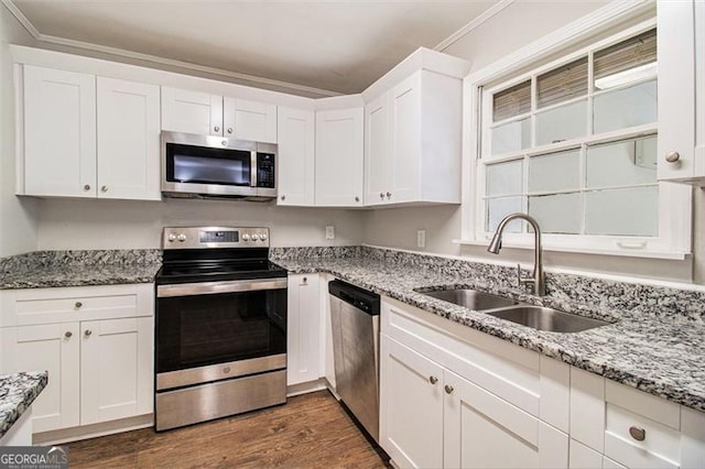 kitchen featuring stainless steel appliances, sink, white cabinetry, crown molding, and dark wood-type flooring