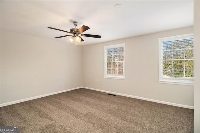 carpeted spare room featuring ceiling fan