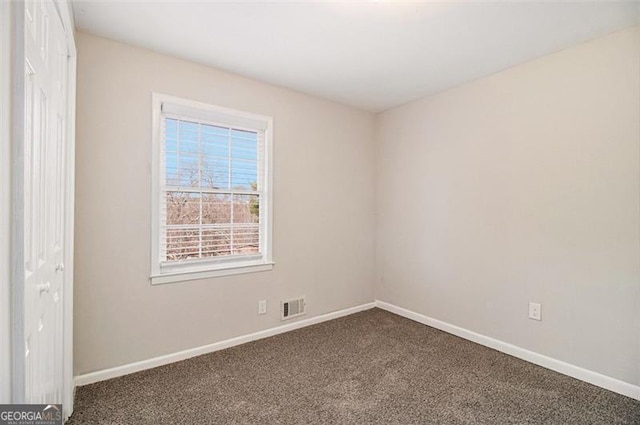 empty room with dark carpet