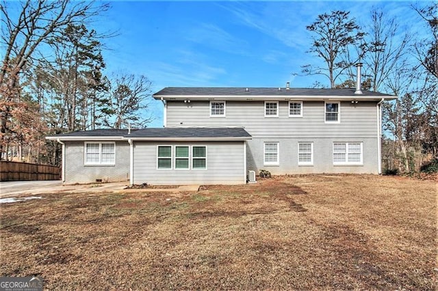 rear view of house with a lawn