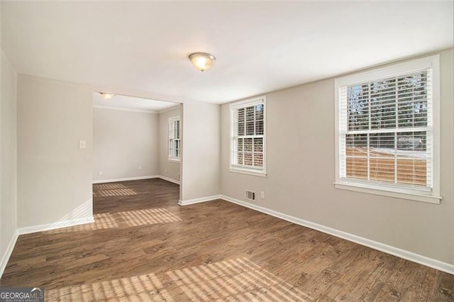 spare room featuring dark hardwood / wood-style flooring