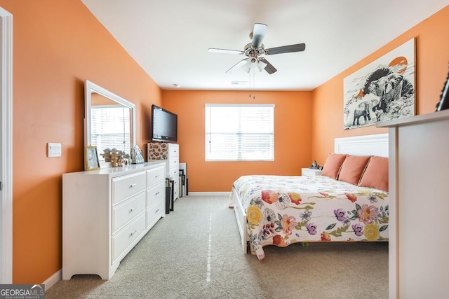 carpeted bedroom with ceiling fan and multiple windows