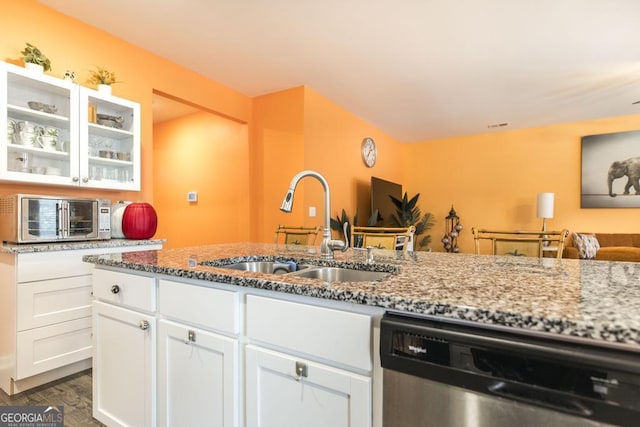 kitchen featuring dishwasher, dark hardwood / wood-style flooring, light stone counters, sink, and white cabinetry