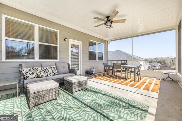 sunroom / solarium featuring ceiling fan