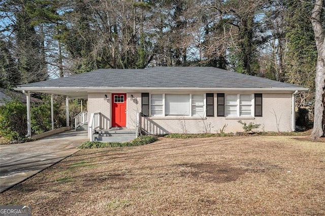 ranch-style house featuring a front yard and a carport