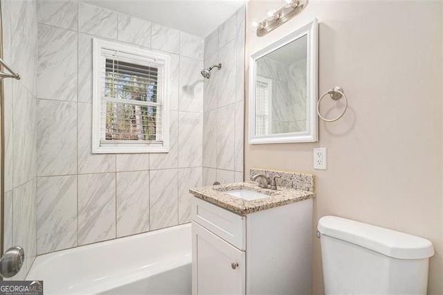 full bathroom with toilet, vanity, and tiled shower / bath combo