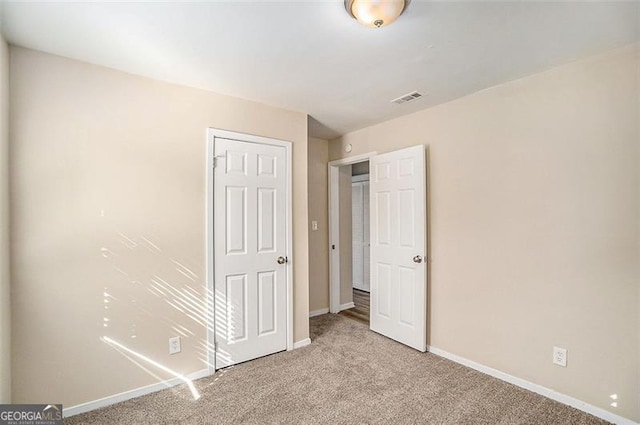 unfurnished bedroom featuring light colored carpet