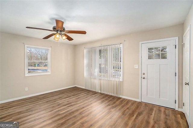 foyer with dark wood-type flooring and ceiling fan