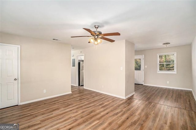 spare room with hardwood / wood-style floors and ceiling fan