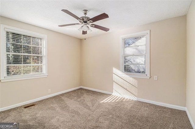 unfurnished room with ceiling fan and carpet flooring