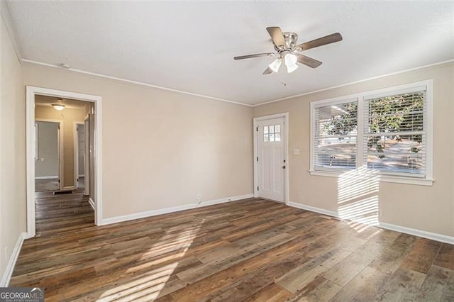 foyer entrance with ceiling fan, dark hardwood / wood-style flooring, and ornamental molding