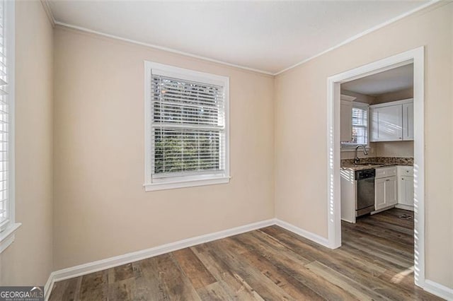 spare room with sink, hardwood / wood-style floors, and ornamental molding