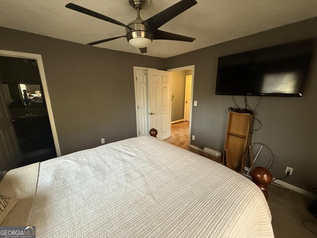 bedroom with ceiling fan and carpet flooring