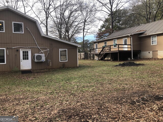 view of yard featuring ac unit and a deck