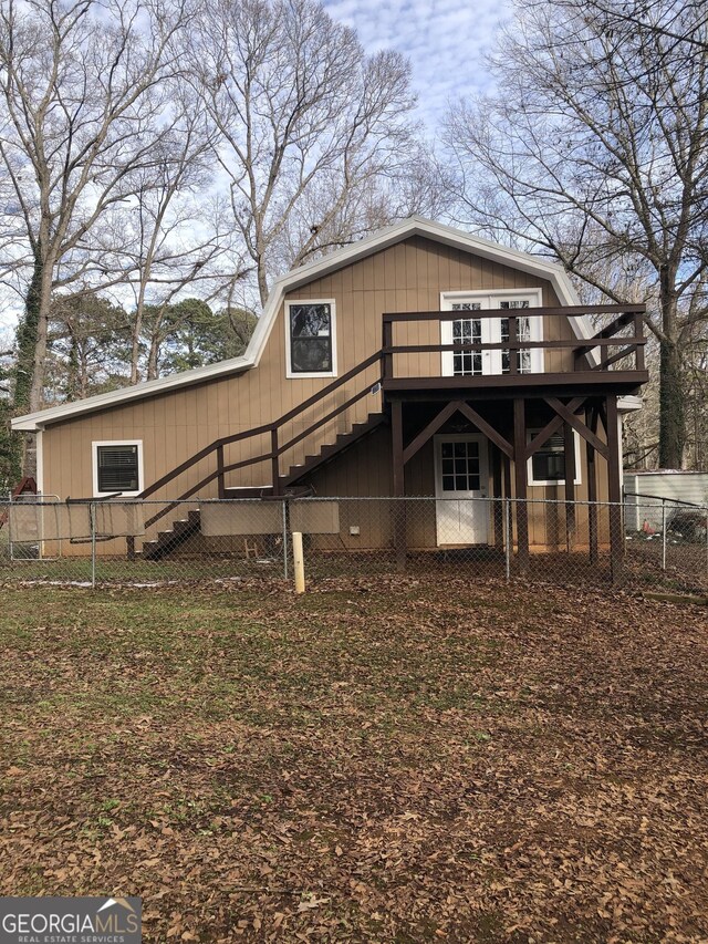 back of property featuring a wooden deck