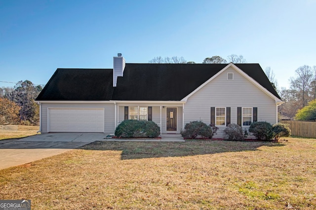 view of front of property featuring a front yard and a garage