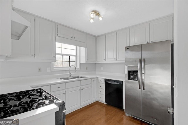 kitchen with wood-type flooring, sink, black dishwasher, white cabinetry, and stainless steel fridge with ice dispenser