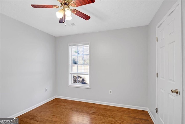 unfurnished room with ceiling fan and wood-type flooring