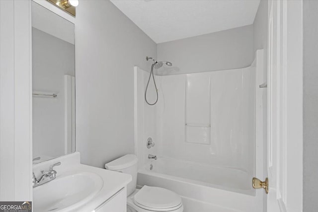 full bathroom with a textured ceiling, toilet, vanity, and  shower combination