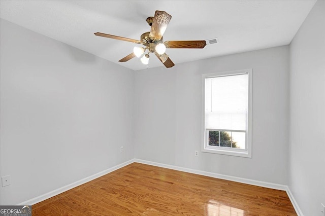 unfurnished room with ceiling fan and wood-type flooring