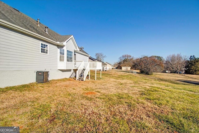 view of yard featuring central AC and a wooden deck