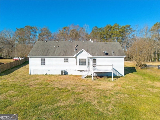 back of house with central AC, a deck, and a yard