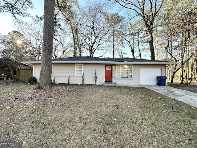 ranch-style house featuring a front yard and a garage