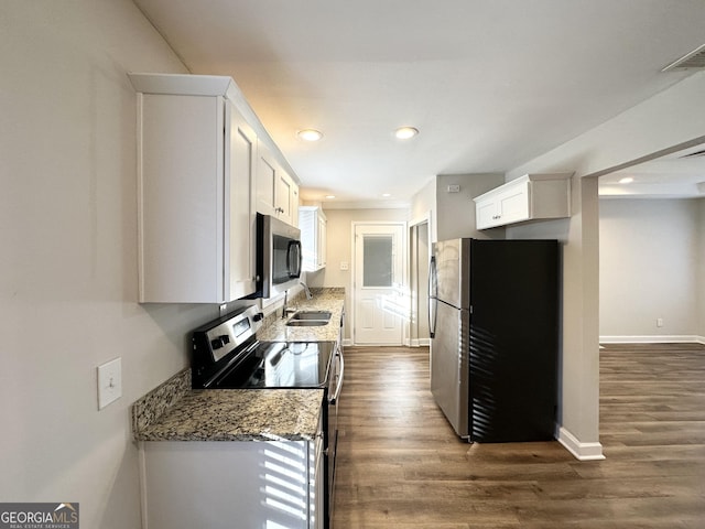 kitchen with sink, white cabinets, stone counters, dark hardwood / wood-style flooring, and appliances with stainless steel finishes