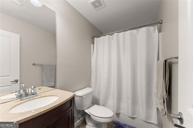 bathroom featuring toilet, shower / bath combination with curtain, vanity, and visible vents